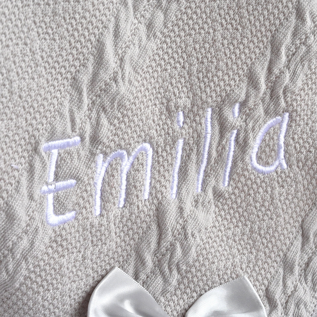 grey knitted blanket with babys name
