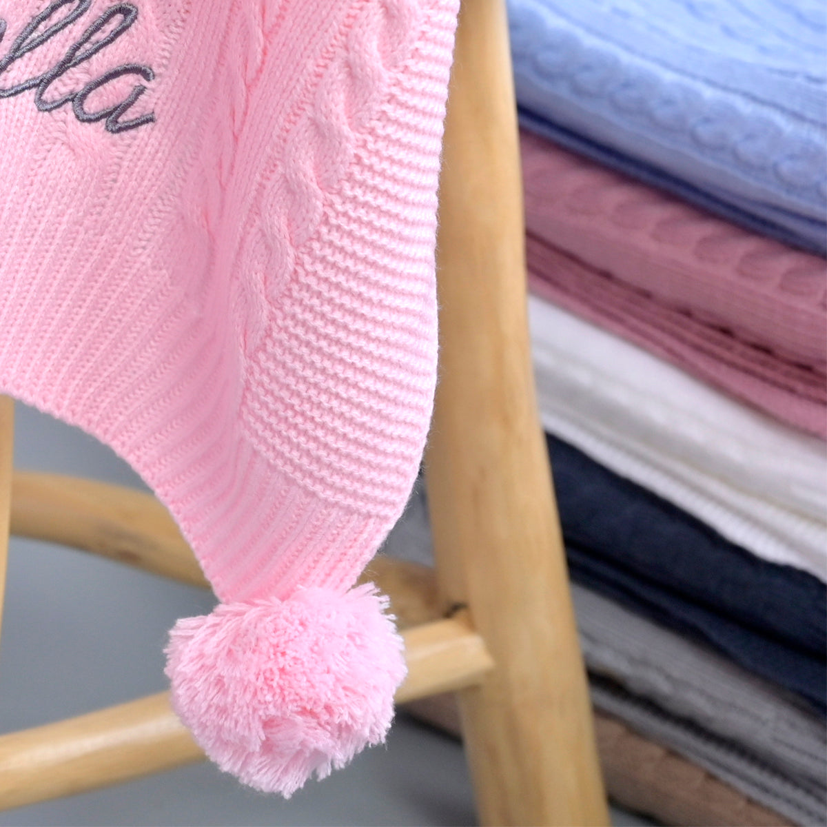 knitted baby blanket with pom pom