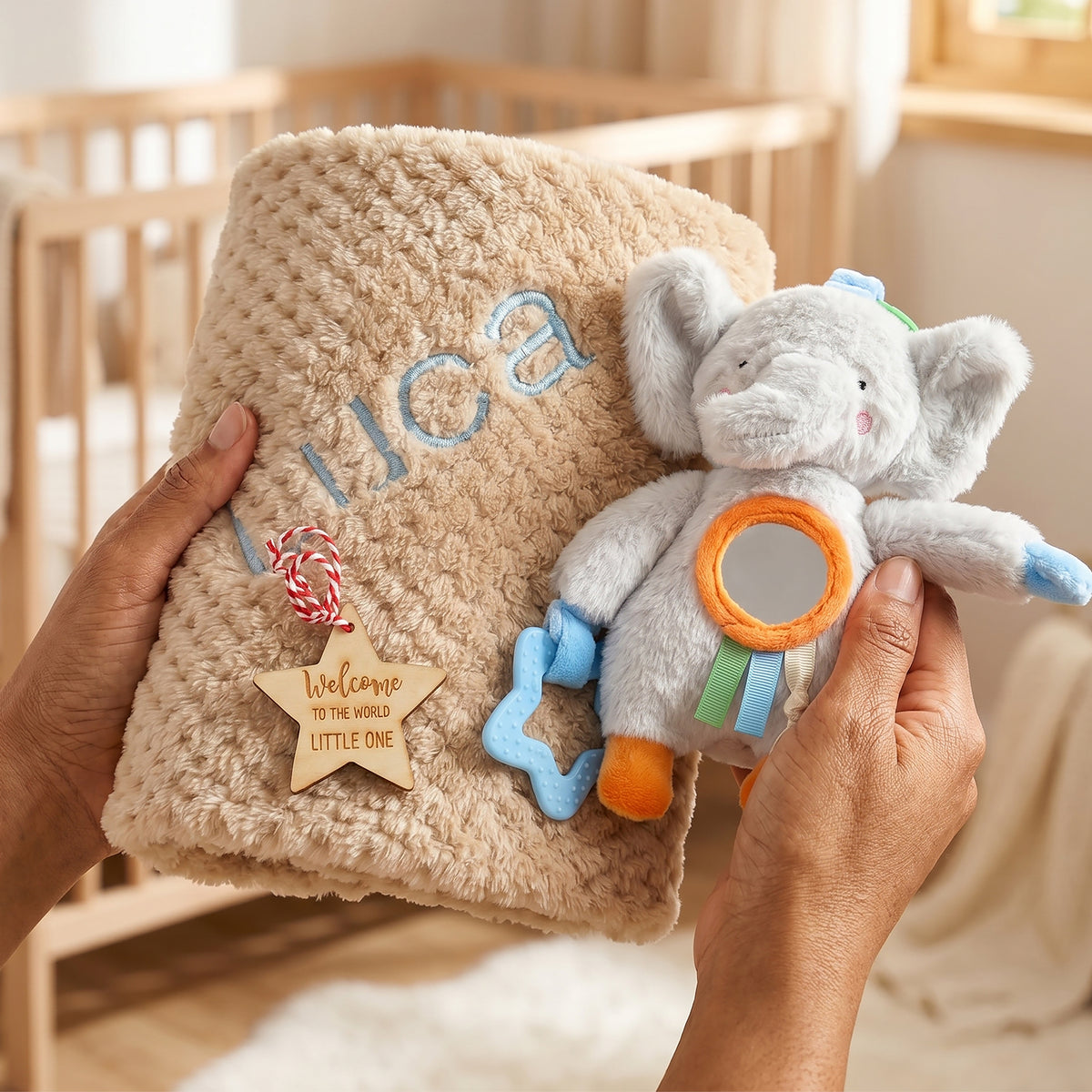 Personalised beige honeycomb baby blanket with name "Luca" embroidered in blue, gift-boxed with an elephant activity toy