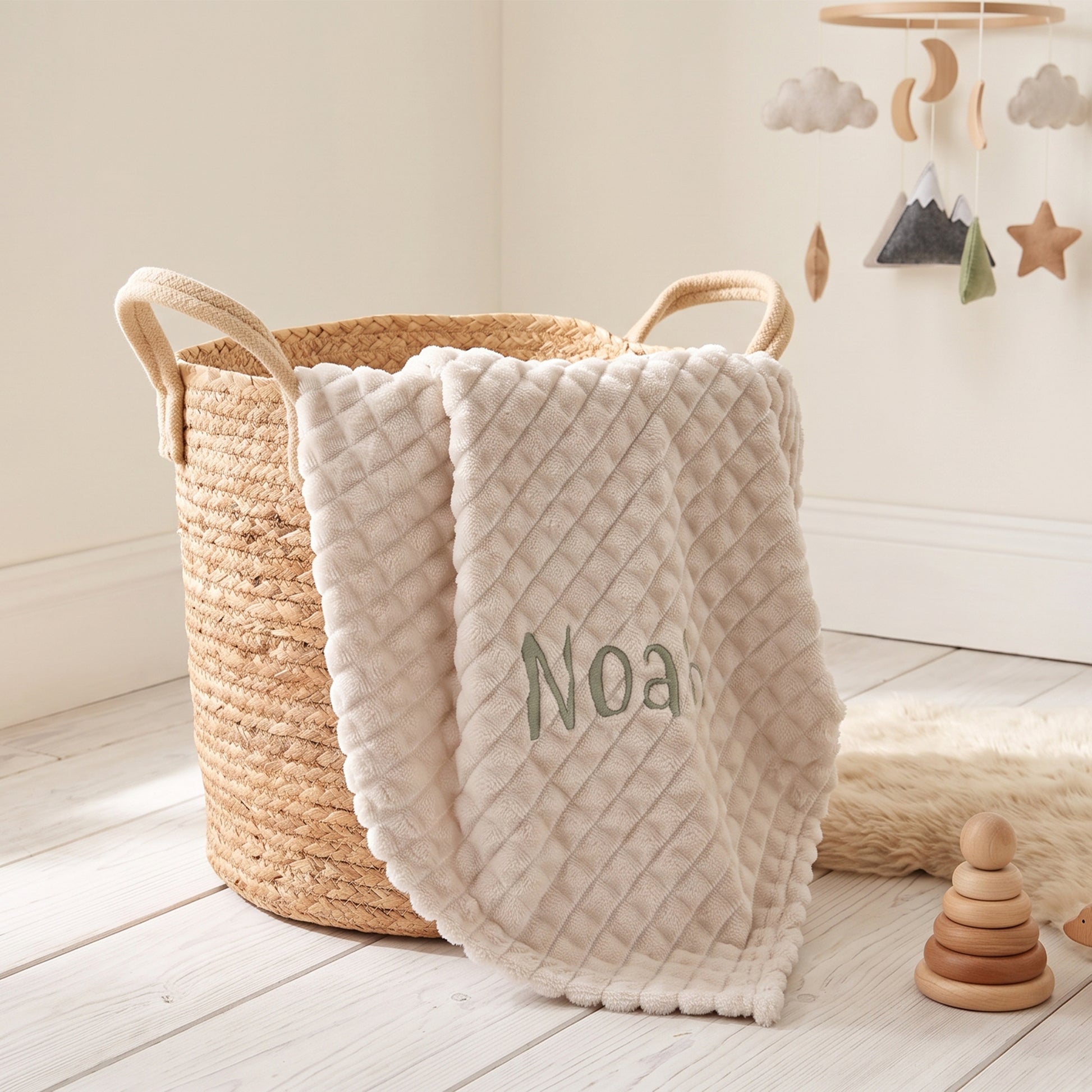 Coffee ribbed fleece baby blanket personalised with the name Noah in sage green embroidery