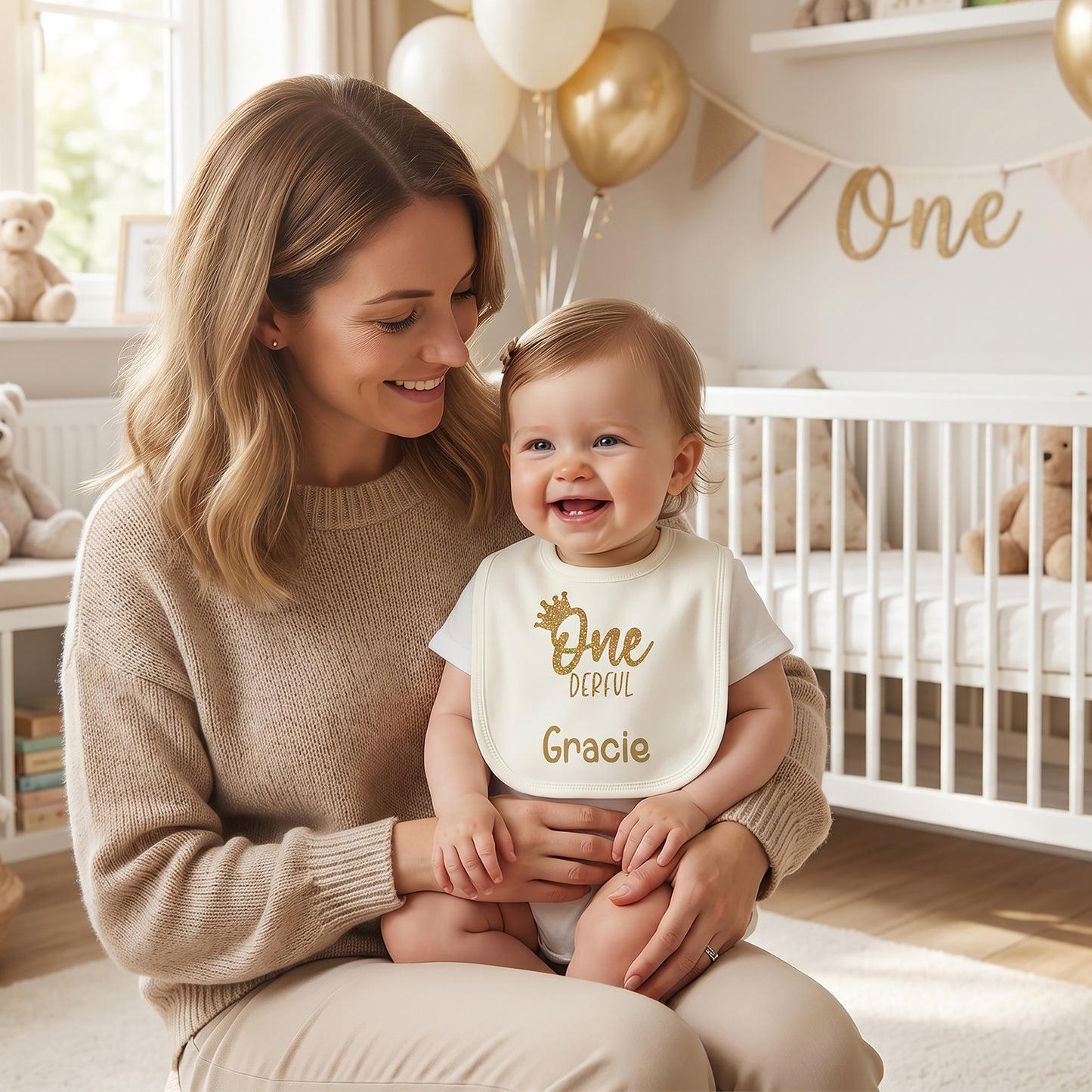 Ivory personalised 1st birthday baby bib with gold glitter crown, "One-derful" wording and name "Gracie" printed in gold