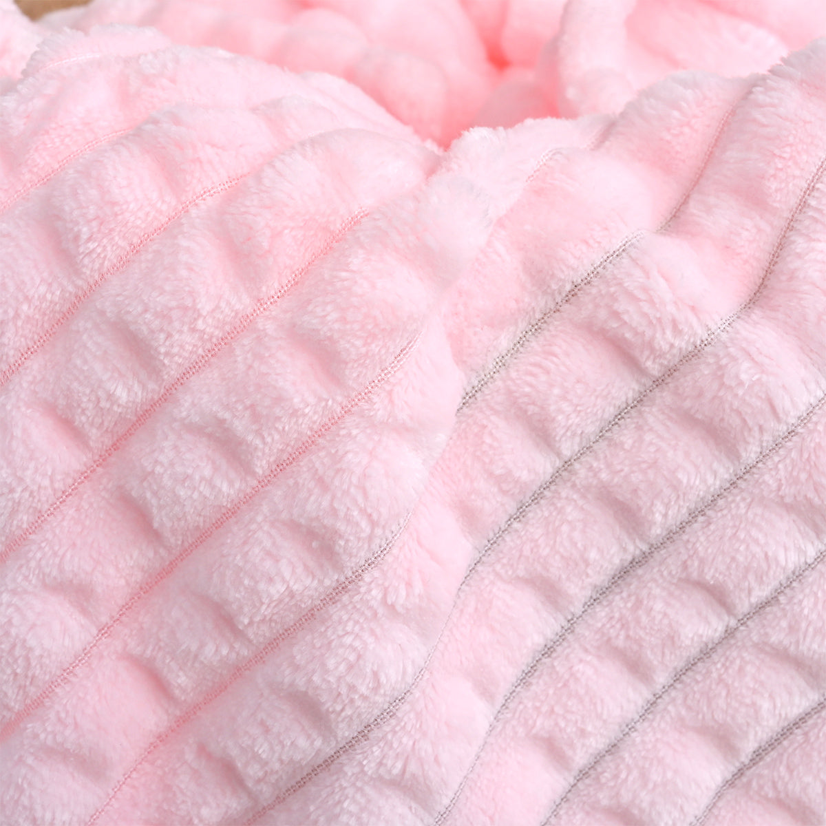 Close-up of pink ribbed fleece texture with part of the embroidered name Amelia visible.