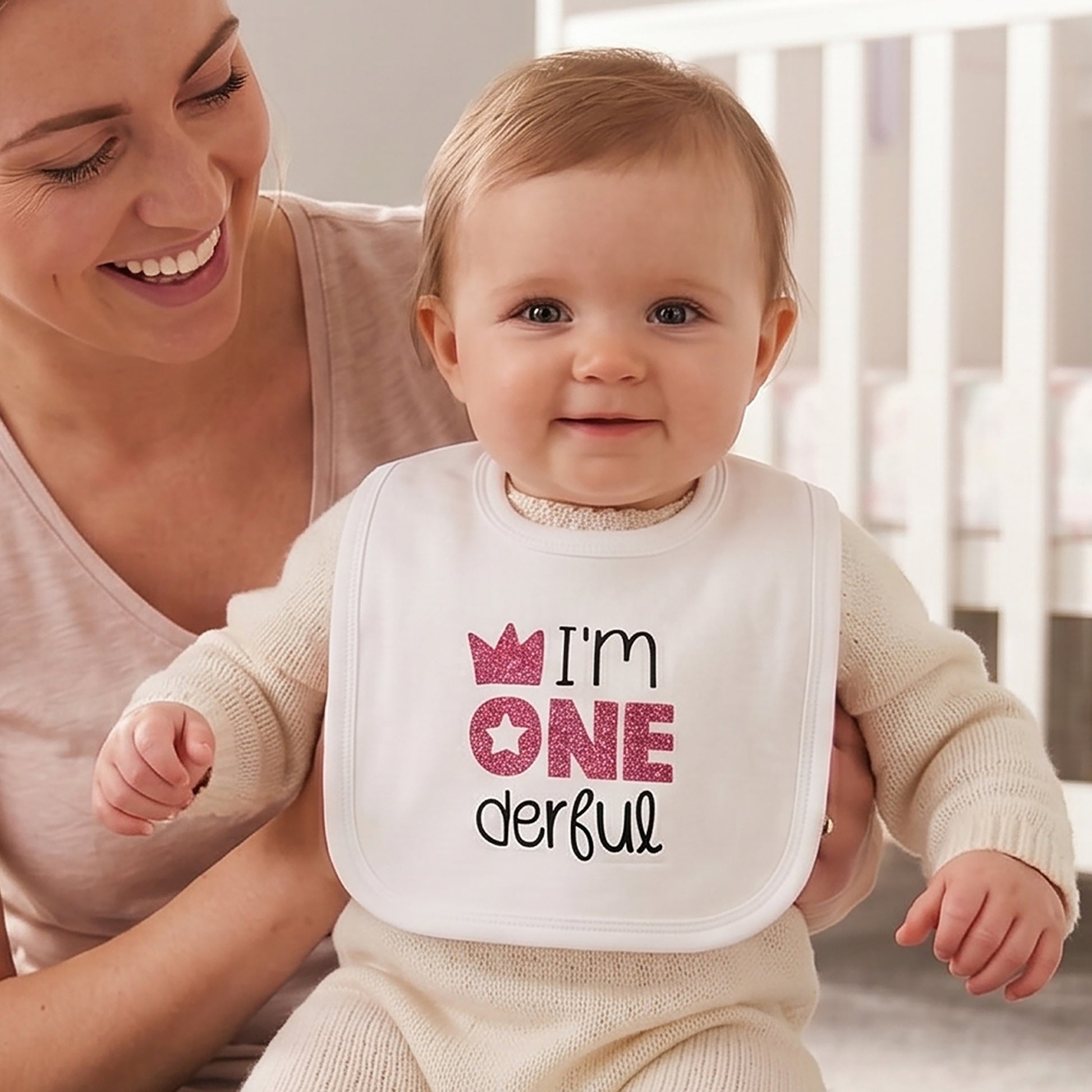 White 1st birthday baby bib with magenta glitter "I'm ONEderful" print, crown and star design